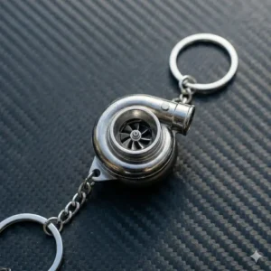 A silver mini turbocharger jdm keychain with a spinning turbine wheel.
