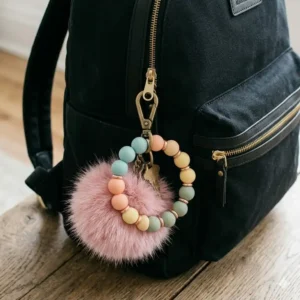 A modern backpack decorated with a keychain big acrylic character charm.