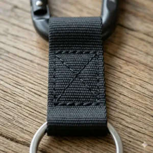 Close-up detail of the reinforced stitching on a braided leather carabiner keyring with strap.