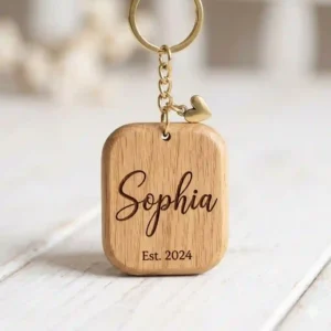 Custom engraved wooden key chain with name carved in an elegant font.