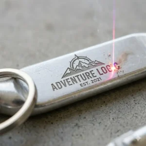 Close-up view of a silver aluminum custom carabiner featuring precise laser-engraved text for a promotional gift.